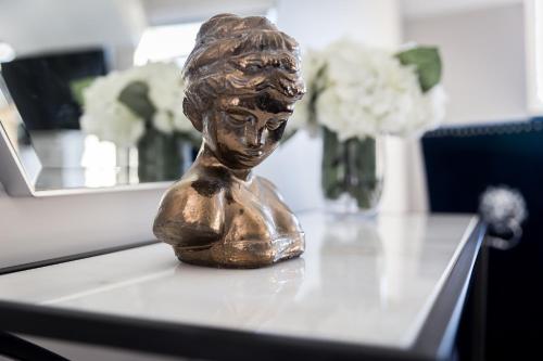 a statue of a little girl sitting on a table at Cricket Field House in Salisbury
