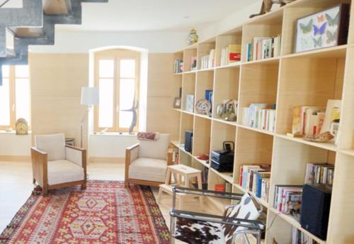a room with a library with bookshelves at La Drapière in Fay-sur-Lignon
