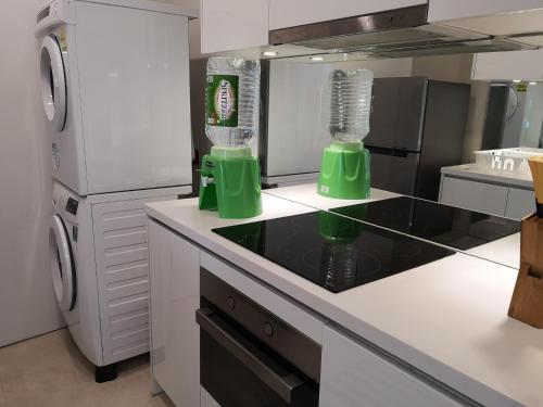 a kitchen with two green blenders on a counter at VORTEX SUITES KLCC by PNUT With NETFLIX in Kuala Lumpur