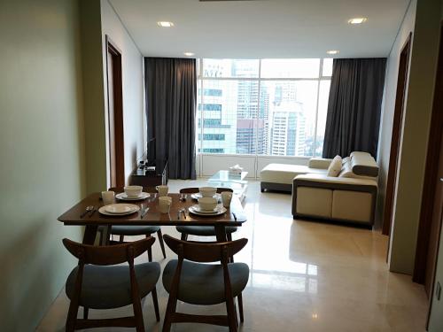 a living room with a table and chairs and a couch at VORTEX SUITES KLCC by PNUT With NETFLIX in Kuala Lumpur