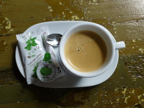 a cup of coffee on a plate with a spoon at 't Brouwershuis in Leende
