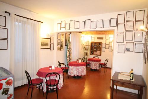 a dining room with red tables and chairs at Villa Nencini in Volterra