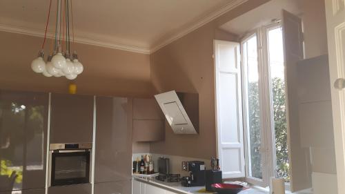 a kitchen with a stove and a window in it at Villa Ippocastano in Lucca
