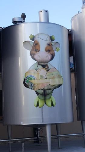 a painting of a cow holding a plate of food at Duplex Métabief in Métabief