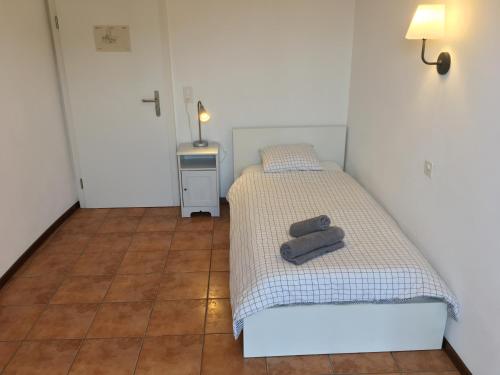 a bedroom with two beds with towels on them at Albergo Ristorante Belcantone in Novaggio