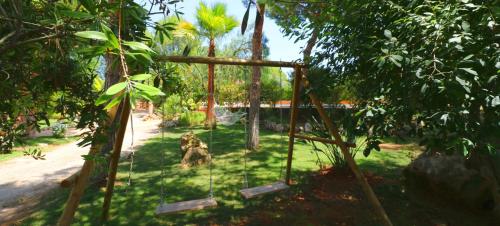 a swing set in a park with trees at Can Crestall in Campos