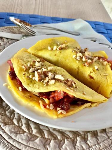 two tacos on a white plate on a table at Albaspina BioAgriturismo in Monticello Conte Otto