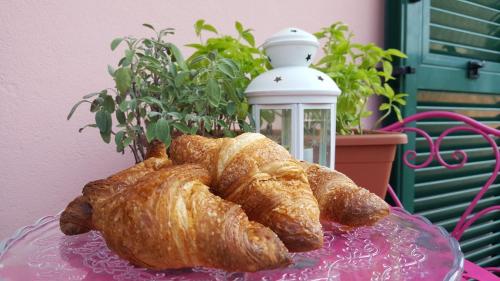 a glass plate with two croissants on a table at B&B Poggio di Balestrino in Balestrino