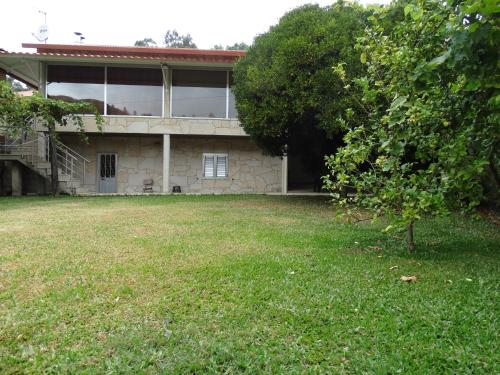 a house with a large yard in front of it at Casa da Mineira T1 in Geres