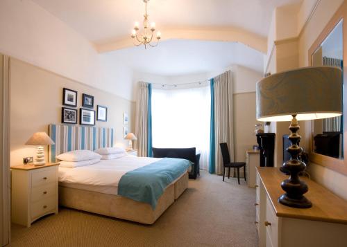 a hotel room with a bed and a window at The Old Custom House in Padstow