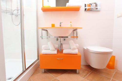 W łazience znajduje się umywalka, toaleta i prysznic. w obiekcie Capo d'Orlando Apartments - Sabbia w mieście Capo dʼOrlando