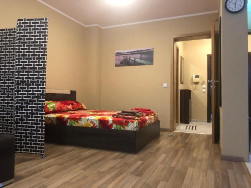 a bedroom with a bed and a clock on the wall at Rakovski Apartment GN / FREE GARAGE in Sofia