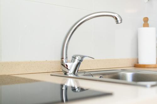 a sink in a kitchen next to a counter at Lima waikiki beach in Corralejo