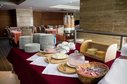 a table with plates and dishes on top of it at Central Park Hotel & Casino in Panama City