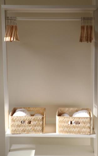 two baskets sitting on a shelf in a closet at Apartamentos Plaza Mayor in Gijón