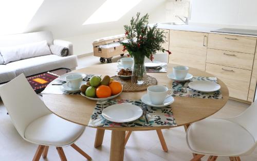 a dining room table with a bowl of fruit on it at Apartamentos Plaza Mayor in Gijón