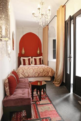 a bedroom with a large bed and a couch at Riad Dar Bahi in Marrakesh