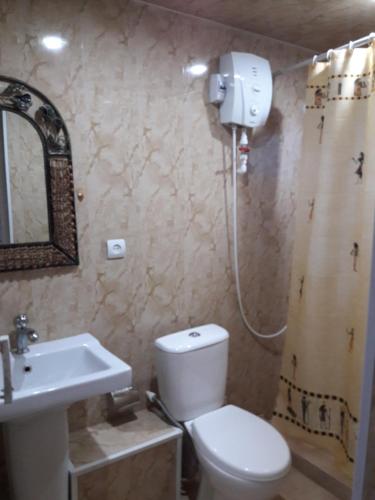 uma casa de banho com um WC branco e um lavatório. em Hotel Today , Խաղաղության լողափ em Shorzha