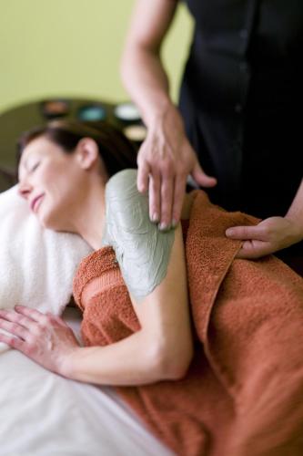a woman laying in bed with a cast on her arm at Red Mountain Resort in St. George