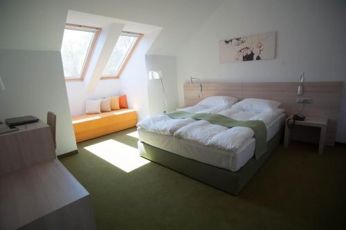 a bedroom with a large bed and a window at Hotel Armatti in Braşov