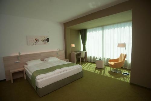 a rendering of a bedroom with a bed and a desk at Hotel Armatti in Braşov