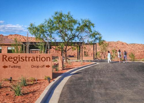 two people walking down a road in a desert at Red Mountain Resort in St. George