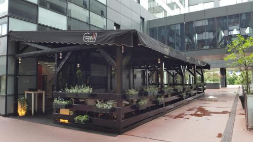 a black tent outside of a building with potted plants at Studio apartman Kristina i Anamaria in Zagreb