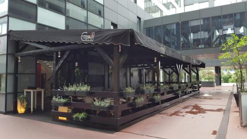 a black tent outside of a building with potted plants at Studio apartman Anamaria in Zagreb
