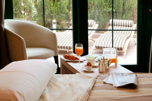 a room with a table with a glass of wine at Hotel MR Les Rotes in Denia