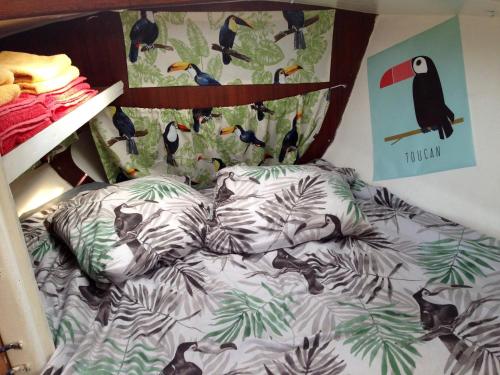 a bed with birds on it in a bedroom at Toucan in Pointe-à-Pitre