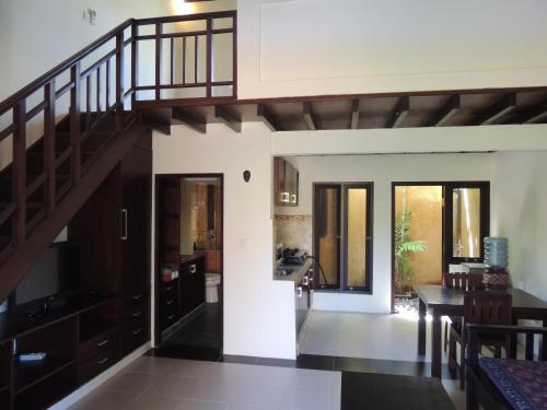 a living room with a staircase in a house at Praschita Bali in Sanur