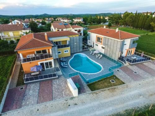 an aerial view of a house with a swimming pool at Apartment in Funtana with Three-Bedrooms 1 in Funtana