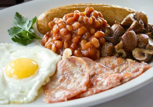 a plate of breakfast food with eggs beans and toast at Arman Hotel Juffair Mall in Manama