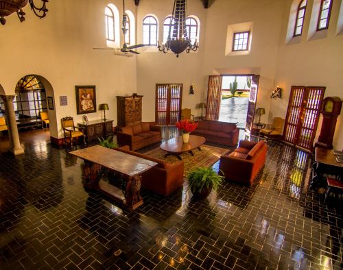 a large living room with couches and a table at Hotel Playa de Cortes in Guaymas