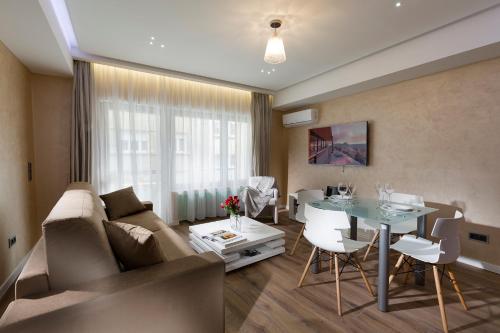 a living room with a couch and a table at The Queen Luxury Apartments - Villa Carlotta in Luxembourg