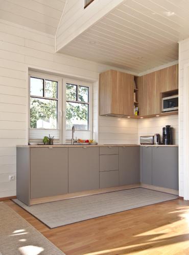 a kitchen with wooden cabinets and a counter top at Holmi Maja in Haapsalu