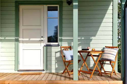 a porch with a table and chairs and a door at Holmi Maja in Haapsalu