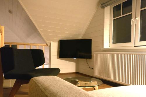 a living room with a couch and a tv at Holmi Maja in Haapsalu