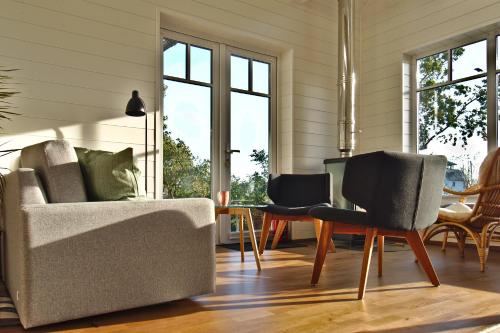 a living room with a couch and a table with chairs at Holmi Maja in Haapsalu