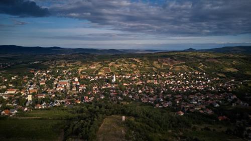 an aerial view of a town in the hills at Szarka Vendégház és Pince in Mád