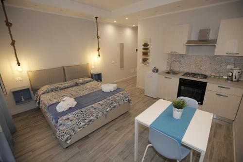 a small bedroom with a bed and a kitchen at Belle Arti in Palermo