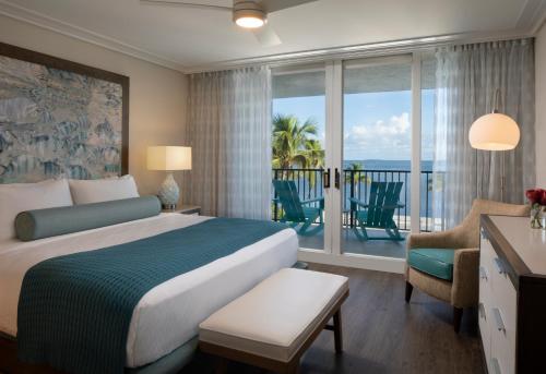 a bedroom with a bed and a view of the ocean at The Laureate Key West in Key West