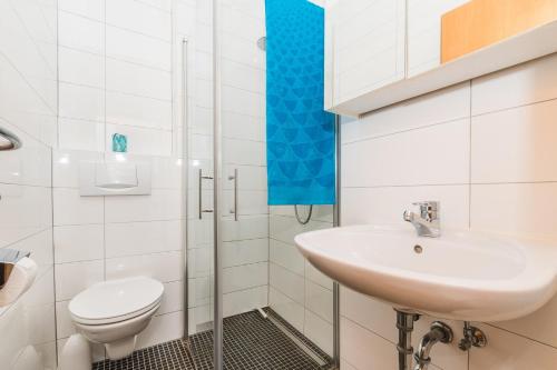 a white bathroom with a sink and a toilet at Apartment Crikvenica, Vinodol 5 in Crikvenica