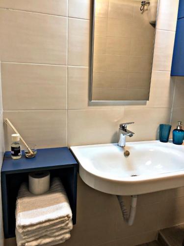 a bathroom with a sink and a mirror at Napoli City Inn in Naples