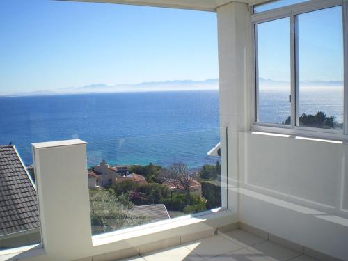 a view of the ocean from a bathroom window at Penguinden - load-shedding free in Simonʼs Town