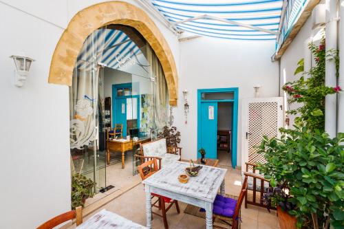 un patio avec une table et des chaises dans un bâtiment dans l'établissement Cypriot Swallow Boutique Hotel, à Lefkosa Turk
