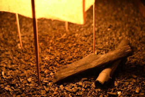 a piece of wood sitting on a pile of rocks at Yamagataya in Kitakata