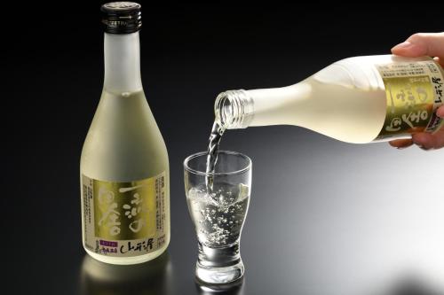 a bottle of wine being poured into a glass at Yamagataya in Kitakata