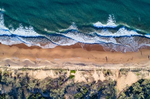 an overhead view of the ocean and a beach at Pavillions on 1770 in Agnes Water