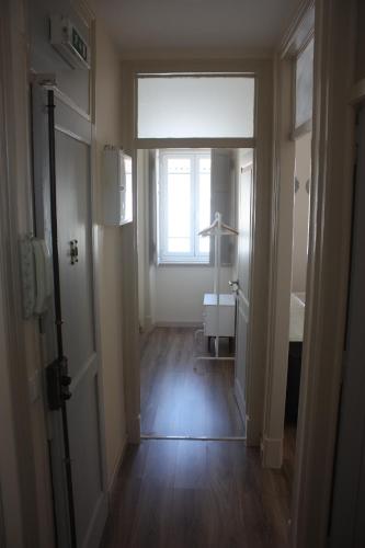 a room with a hallway with a sink and a window at Casa da Parede - Beach & Mountain in Parede